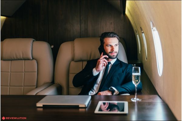 A businessman taking a call in a private jet