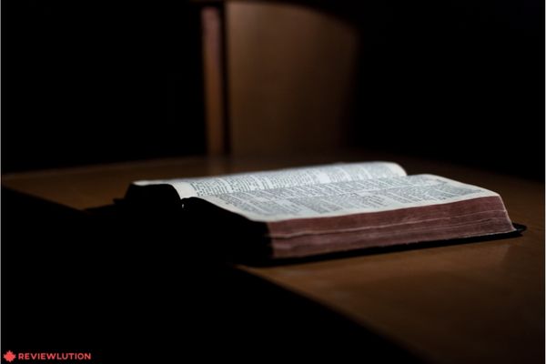 An open bible on a wooden table