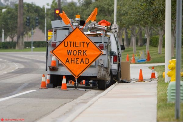 utility work ahead sign behind a truck 