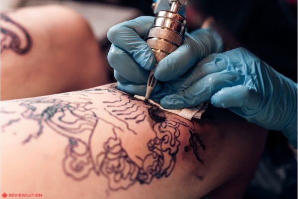 tattoo artist drawing a tattoo 