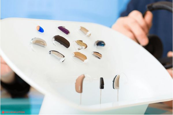 Different types of Hearing Aids on a white surface