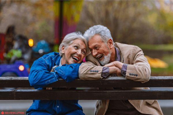 happy couple with RRSP tax-free savings sitting on a bench 