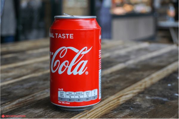 CocaCola trademark on can on a wooden table