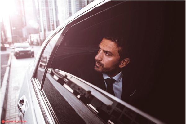 a businessman looking out of a car window