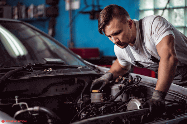 a mechanic inspecting a car motor