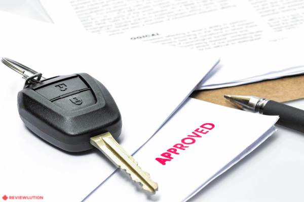 an approved car loan application and a car key