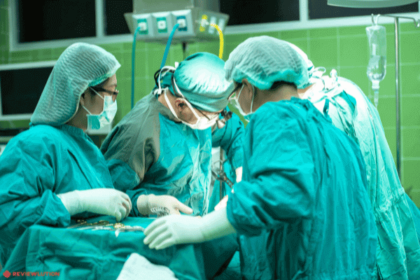 4 doctors performing plastic surgery in an OR