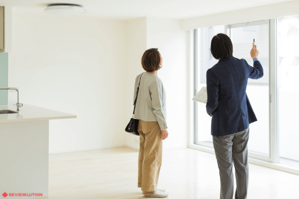 a real estate agent showing an apartment to a woman