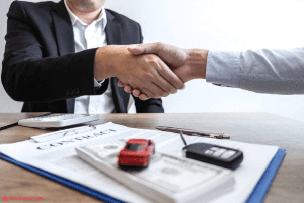 two people shaking hands over a lease contract